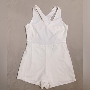 White romper, backless with crisscross straps. Brand new/ never worn.